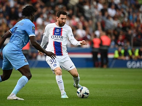 Paris Saint-Germain's Argentine forward Lionel Messi (right) controls the ball during the French L1 football match between Paris Saint-Germain (PSG) and ES Troyes AC at The Parc des Princes Stadium in Paris on October 29, 2022.