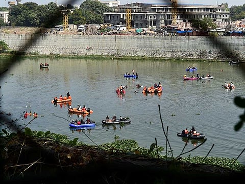Rescue personnel conduct search operations after a bridge across the river Machchhu collapsed at Morbi in India's Gujarat state on October 31, 2022.  