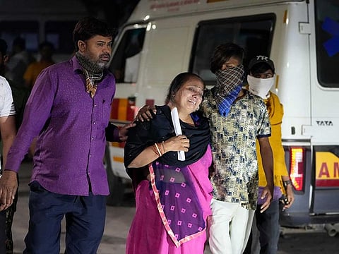 Relatives of a victim mourn after a cable bridge across the Machchu river collapsed in Morbi town of western state Gujarat, India, Monday, Oct. 31, 2022.  