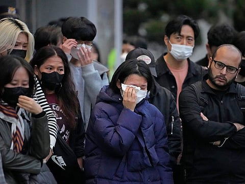 Mourners gather as they pay tribute for victims of a deadly accident following Saturday night's Halloween festivities on the street near the scene in Seoul, South Korea, Monday, Oct. 31, 2022.