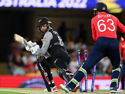 New Zealand's Devon Conway, left, looks back as England's Jos Buttler attempts a stumping during the T20 World Cup cricket in Brisbane, Australia. England won by 20 runs.