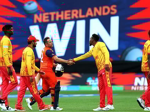 Netherlands' Roelof van der Merwe (centre) shakes hands with Zimbabwe players after the ICC men's Twenty20 World Cup 2022 cricket match at Adelaide Oval in Adelaide.