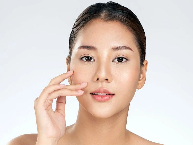 Woman touching her face during skincare routine 