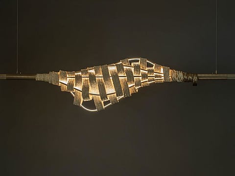 Saudi Arabian designer Huda Al-Aithan designed a suspended light inspired by the regional craft of ‘Safeefah’, or palm frond weaving, and made in collaboration with Emirati craftswomen.