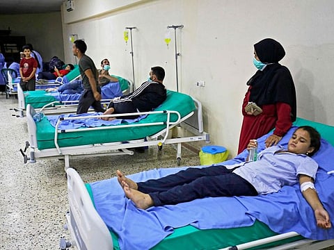 Patients infected in an outbreak of Vibrio cholera receive treatment in a mosque hall converted into a field hospital in the town of Bebnine in the Akkar district in north Lebanon. 