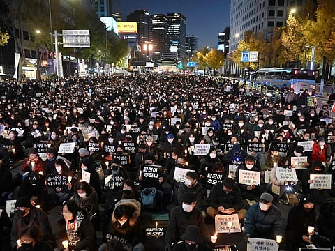 People take part in a candlelight vigil to commemorate the 156 people killed in the October 29 Halloween crowd crush, in Seoul on November 5, 2022. 