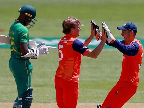 Netherlands’ Scott Edwards (right) congratulates teammate Bas de Leede after defeating South Africa in their T20 World Cup cricket match in Adelaide, Australia, on November  6, 2022 