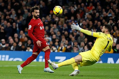 Liverpool's Egyptian striker Mohamed Salah (left) scores his team's second goal past Tottenham Hotspur's French goalkeeper Hugo Lloris during the English Premier League football match at Tottenham Hotspur Stadium in London.
