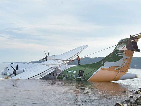 A rescuer ties a winch to pull out the crashed Precision Air flight that was carrying 43 people and plunged into Lake Victoria as it attempted to land in the lakeside town of Bukoba, Tanzania on November 6, 2022. 
