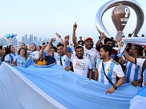 Argentina's fans cheer in front of the FIFA World Cup countdown clock in Doha ahead of the Qatar 2022 FIFA World Cup football tournament.