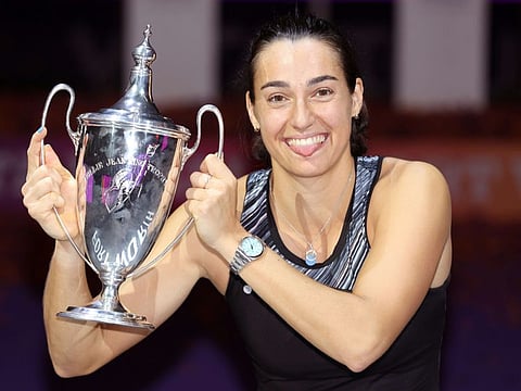 Caroline Garcia of France celebrates with the Billie Jean King Trophy after defeating Aryna Sabalenka of Belarus in the final of the WTA Finals on Monday.