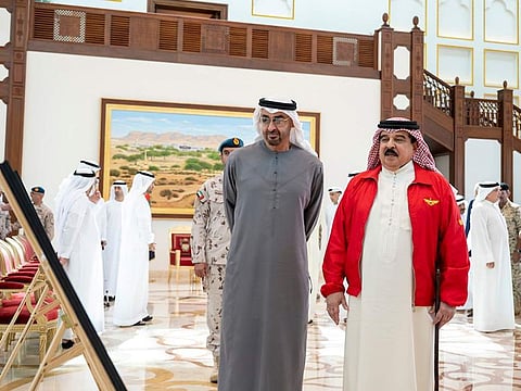 President His Highness Sheikh Mohamed bin Zayed Al Nahyan with King Hamad bin Isa Al Khalifa of Bahrain look at photographs upon arriving at Sakhir Air Base, Bahrain. 