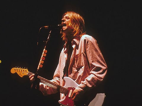 Nirvana frontman Kurt Cobain performing on stage.