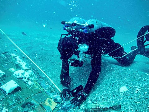 Underwater explorer and marine biologist Mike Barnette and wreck diver Jimmy Gadomski explore a 20-foot segment of the 1986 Space Shuttle Challenger that the team discovered in the waters off the coast of Florida.