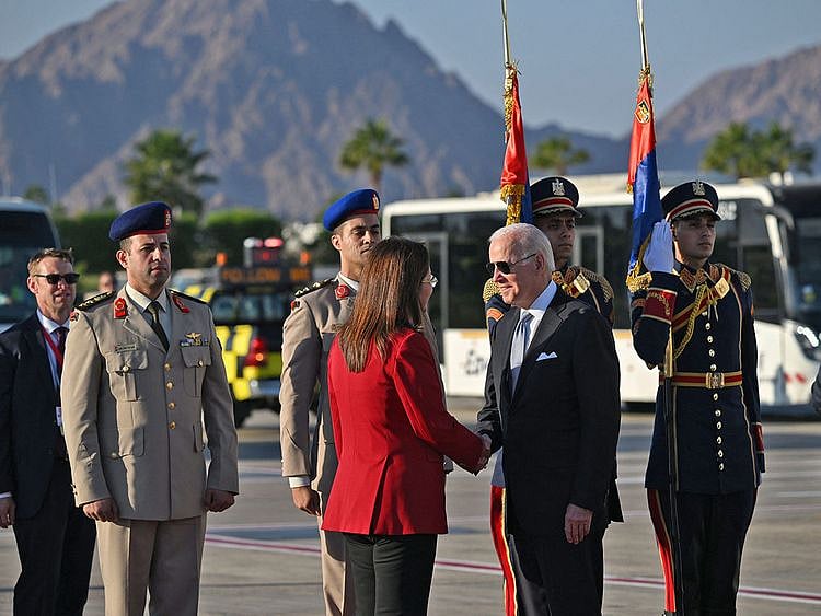 US President Joe Biden is greeted upon his arrival at the airport of Egypt's Red Sea resort city of Sharm Al Sheikh, to attend the COP27 climate conference, on November 11, 2022.