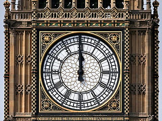 In this file photo taken on August 14, 2017 One of the four faces of the Great Clock of the Elizabeth Tower, commonly referred to as Big Ben, is pictured at the Houses of Parliament at midday in central London.