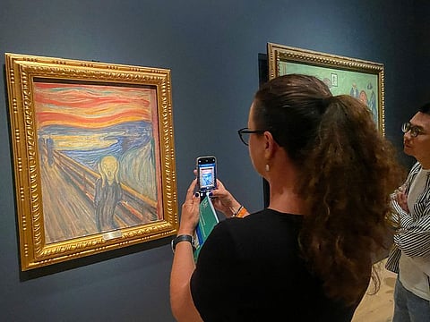 A visitor taking pictures of Edvard Munch's iconic painting 'The Scream' at the National Museum in Oslo, Norway.