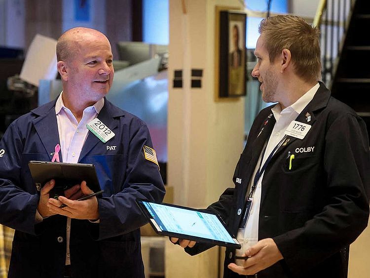 Traders work on the floor of the New York Stock Exchange stocks Wall Street
