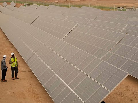 Engineers at photovoltaic solar panels at Benban Solar Park, one of the world's largest solar power plant in the world, in Aswan.