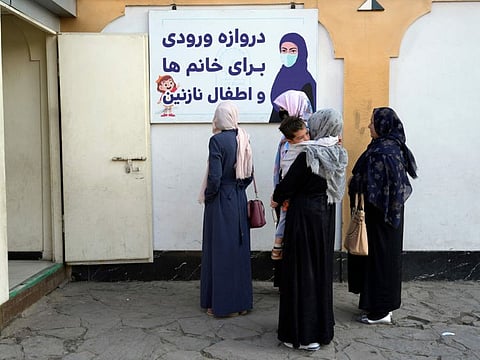 Afghan women stand outside an amusement park, in Kabul on November 10, 2022.  The Taliban have banned women from using gyms and parks in Afghanistan.