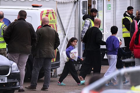 Detainees are seen inside the Manston short-term holding centre for migrants, near Ramsgate, south east England on November 3, 2022. British immigration minister Robert Jenrick on Tuesday vowed "more radical" policies to counter illegal migration as record numbers make the treacherous crossing of the Channel in small boats.  