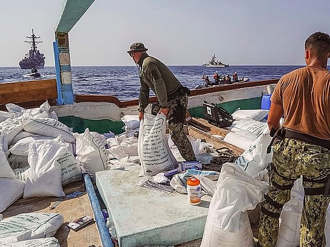 In this photo released by the US Navy, sailors inventory urea and ammonium perchlorate found on a dhow intercepted in the Gulf of Oman.
