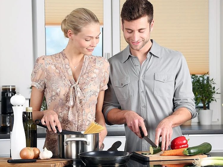 A couple preparing food in the kitchen 