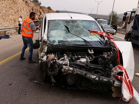 A damaged vehicle is seen at the scene of an attack, at the Ariel Industrial Zone in West Bank on November 15, 2022.  