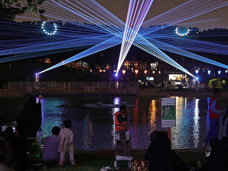 Saudis attending the Noor Riyadh lighting festival held at Al Salam Park in the Saudi capital Riyadh as part of Riyadh Season activities.
