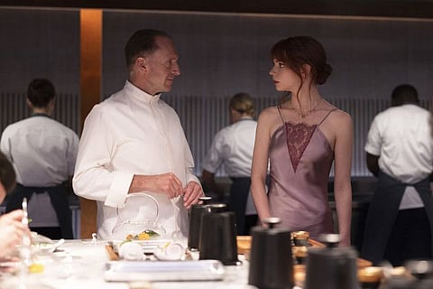 This image released by Searchlight Pictures shows Ralph Fiennes, left, and Anya Taylor-Joy in a scene from the film "The Menu."
