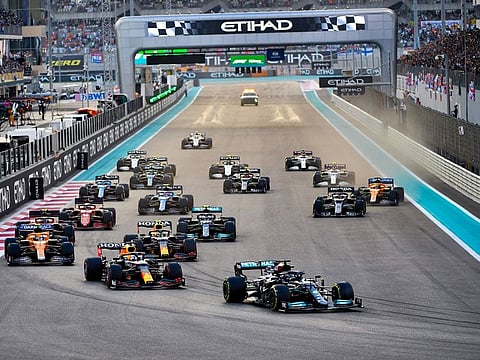 Lewis Hamilton of Mercedes takes early lead over Max Verstappen of Red Bull at the start of Etihad Airways Formula 1 Abu Dhabi Grand Prix at Yas Marina Circuit on December 12, 2021. 