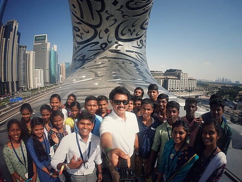 Tamil Nadu Minister of School Education, Anbil Mahesh Poyyamozhi taking photo with a group of Tamil Nadu students during their trip to Dubai