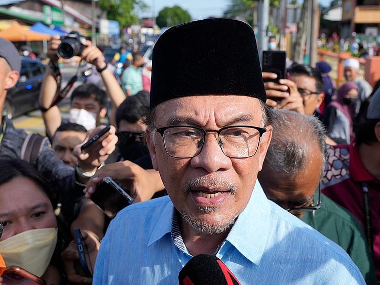 Malaysian opposition leader Anwar Ibrahim answers journalists' questions after casting his vote at a polling station in Seberang Perai, Penang state, Malaysia, Saturday, Nov. 19, 2022. Malaysians began casting ballots Saturday in a tightly contested national election that will determine whether the country's longest-ruling coalition can make a comeback after its electoral defeat four years ago.