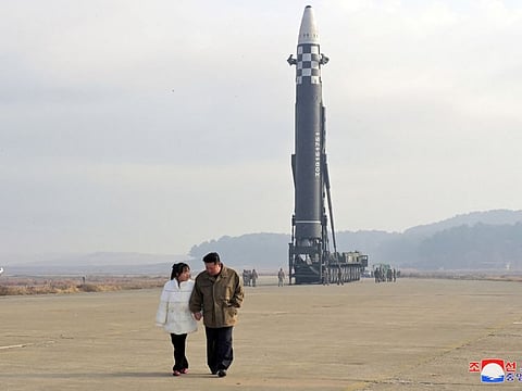 North Korean leader Kim Jong Un walks away with his daughter from an intercontinental ballistic missile (ICBM) in this undated photo released on November 19, 2022 by North Korea's Korean Central News Agency (KCNA). 