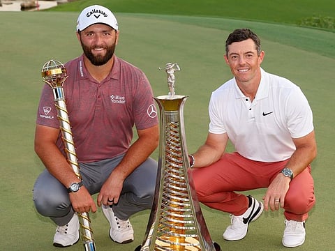 Rahm with the DP World Tour Championship Trophy & McIlroy with the Harry Vardon Trophy
