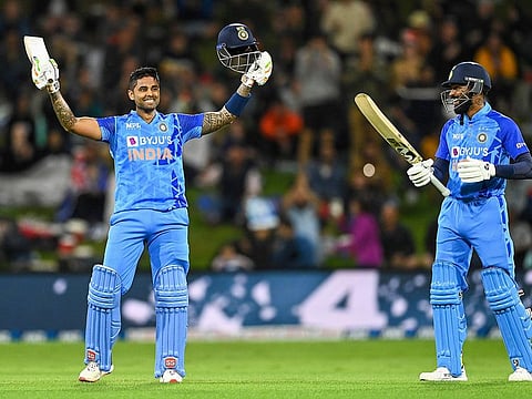 India's Suryakumar Yadav (left) raises his bat after completing his century during the 2nd T20I match against New Zealand, at Bay Oval, in Mount Maunganui.