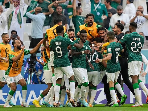 Saudi Arabia's Salem Al-Dawsari is congratulated after scoring his side's 2nd goal during the World Cup group C soccer match between Argentina and Saudi Arabia at the Lusail Stadium in Lusail, Qatar