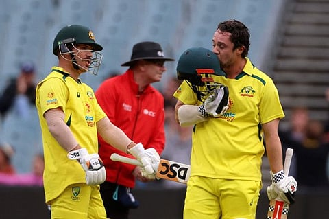 Australia's Travis Head (right) celebrates after reaching his century against against England as teammate David Warner pats him during their third One Day International in Melbourne on Tuesday.