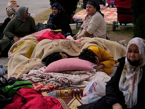 People rest outside their homes in Duzce, Turkey, on  Nov. 23, 2022, after a magnitude 5.9 earthquake hit a town in northwest Turkey.
