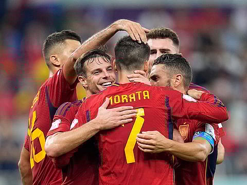 Spain's Alvaro Morata, center, celebrates with teammates after scoring his side's seventh goal during the World Cup group E soccer match between Spain and Costa Rica.