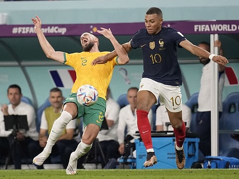 France's Kylian Mbappe (right) and Australia's Milos Degenek fight for the ball during the World Cup group D match at the Al Janoub Stadium in Al Wakrah, Qatar.