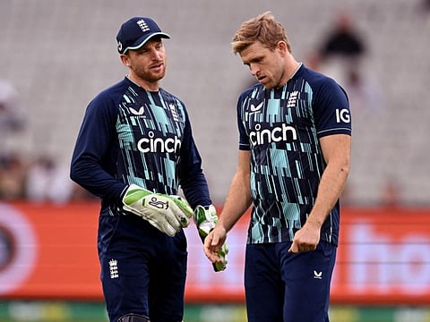 England captain Jos Buttler (left) speaks with teammate David Willey during the third One Day International against Australia at MCG in Melbourne on Tuesday.