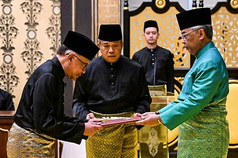 Malaysia's King Sultan Abdullah Sultan Ahmad Shah, right, and newly appointed Prime Minister Anwar Ibrahim, left, take part in the swearing-in ceremony at the National Palace  in Kuala Lumpur, Malaysia, Thursday, Nov. 24, 2022.