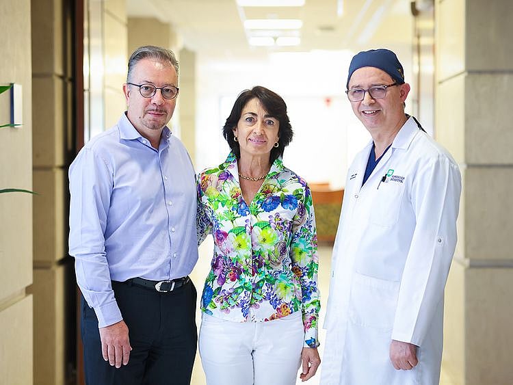  Dr Parviz Dolati (right) with the patient (centre)