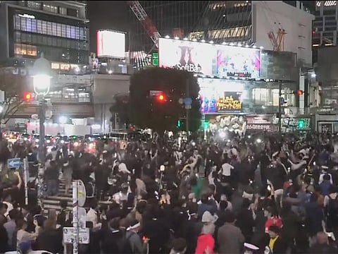 Japan fans celebrated when light turned red, dispersed when it turned green, thus leaving the traffic flow undisturbed.