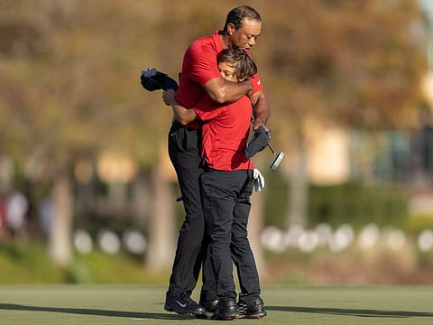 Tiger Woods and son Charlie Woods hug after the final round of the PNC Championship last year.