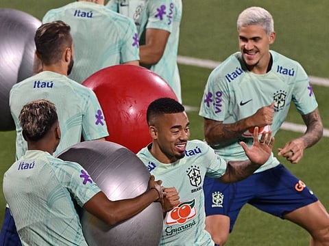 Brazil's forwards Gabriel Jesus (centre) and Pedro (right) take part in a training session at Al Arabi SC stadium in Doha.