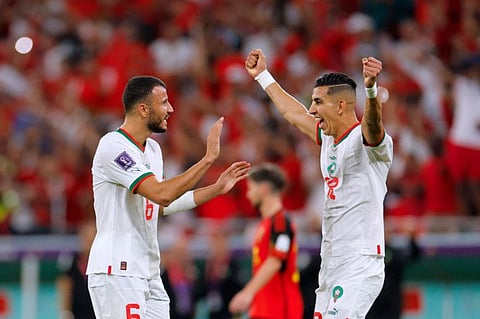 Morocco's Romain Ghanem Saiss (left) and Noussair Mazraoui celebrate their team's second goal during the Qatar 2022 World Cup Group F match against Belgium at the Al-Thumama Stadium in Doha. Morocco won 2-0.