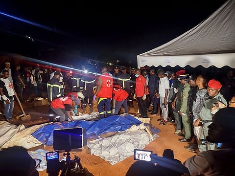 Rescuers prepare to carry a body after a landslide, which killed people who were attending a funeral, the governor of Cameroon's Centre Region said, in Yaoundi.