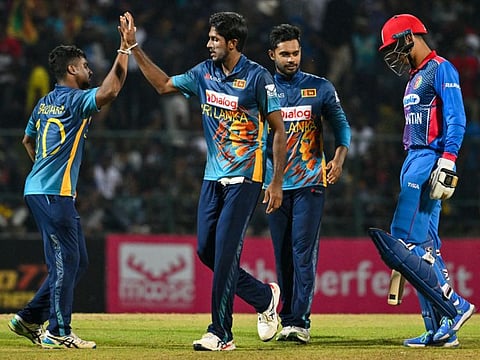 Sri Lanka's Kasun Rajitha (second from left) celebrates after taking the wicket of Afghanistan's Mujeeb Ur Rahman (right) during the second One Day International in Kandy on Sunday.
